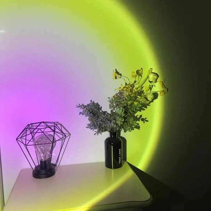 LED sunset lamp projecting a warm circular light pattern onto a wall for room ambiance.