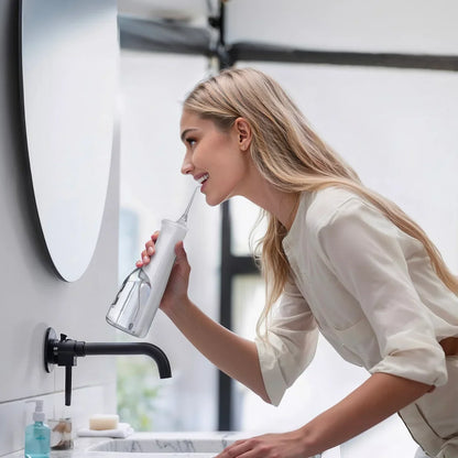 Puursmile water flosser being used at a bathroom sink for daily teeth and gum cleaning