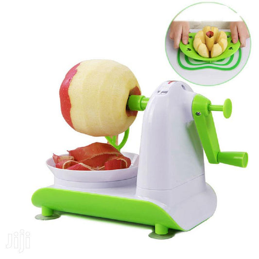 Handheld fruit peeler removing thin skin from fresh apple on cutting board