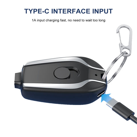 Emergency portable key chain charger attached to a metal keyring for quick smartphone charging.