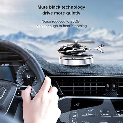 Helicopter-shaped car air freshener mounted on a vehicle air vent to diffuse cabin fragrance.
