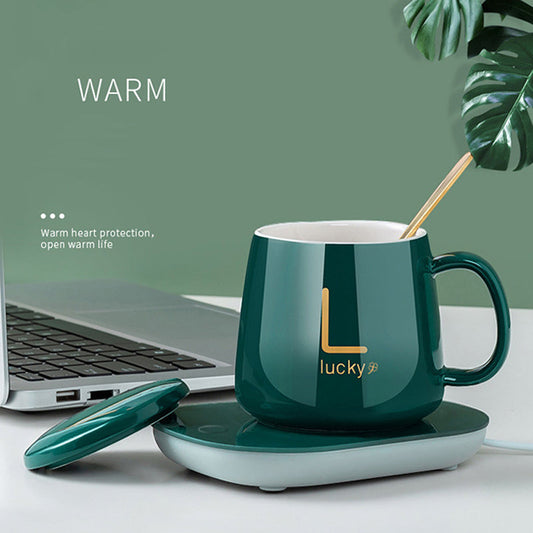 USB electric coffee warmer coaster maintaining hot beverage temperature for a mug on a desk