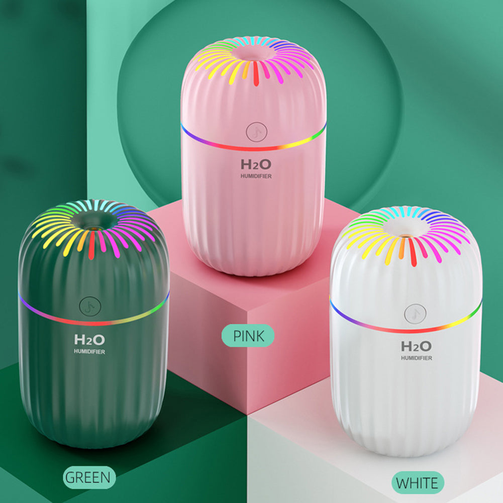 Compact 3 in 1 air humidifier producing visible mist on a desk for home or office