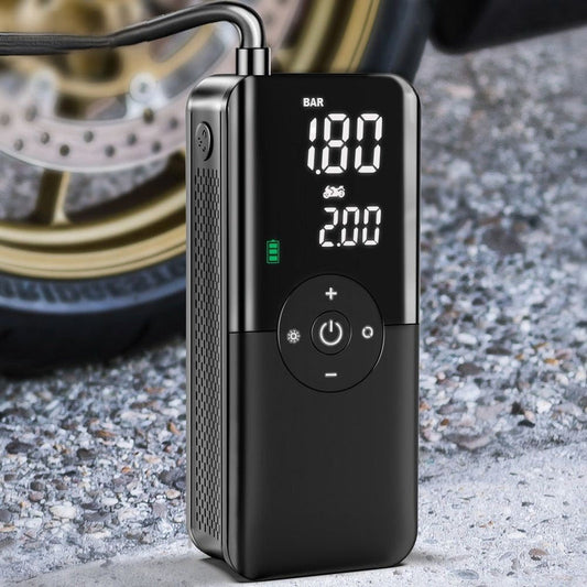 Portable electric air pump with hose attachment shown beside a bicycle tire for inflation.
